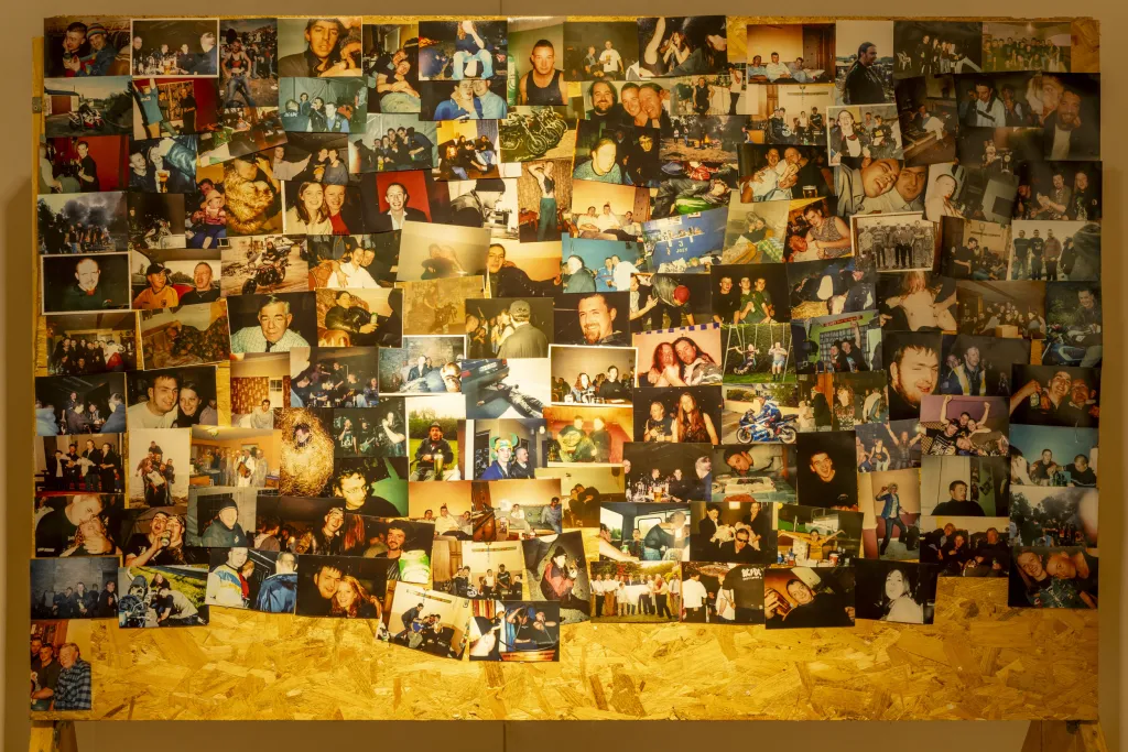 A large piece of MDF with a collage of photographs stuck to it. 