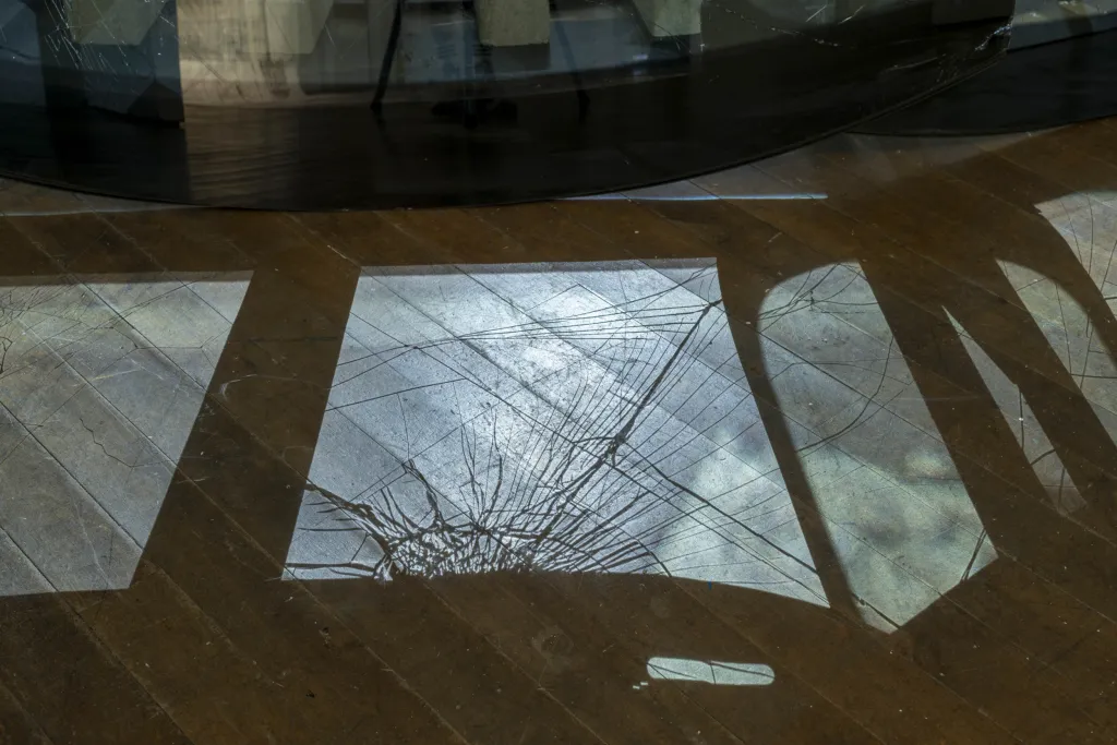 Reflection of broken glass on a wooden floor. 